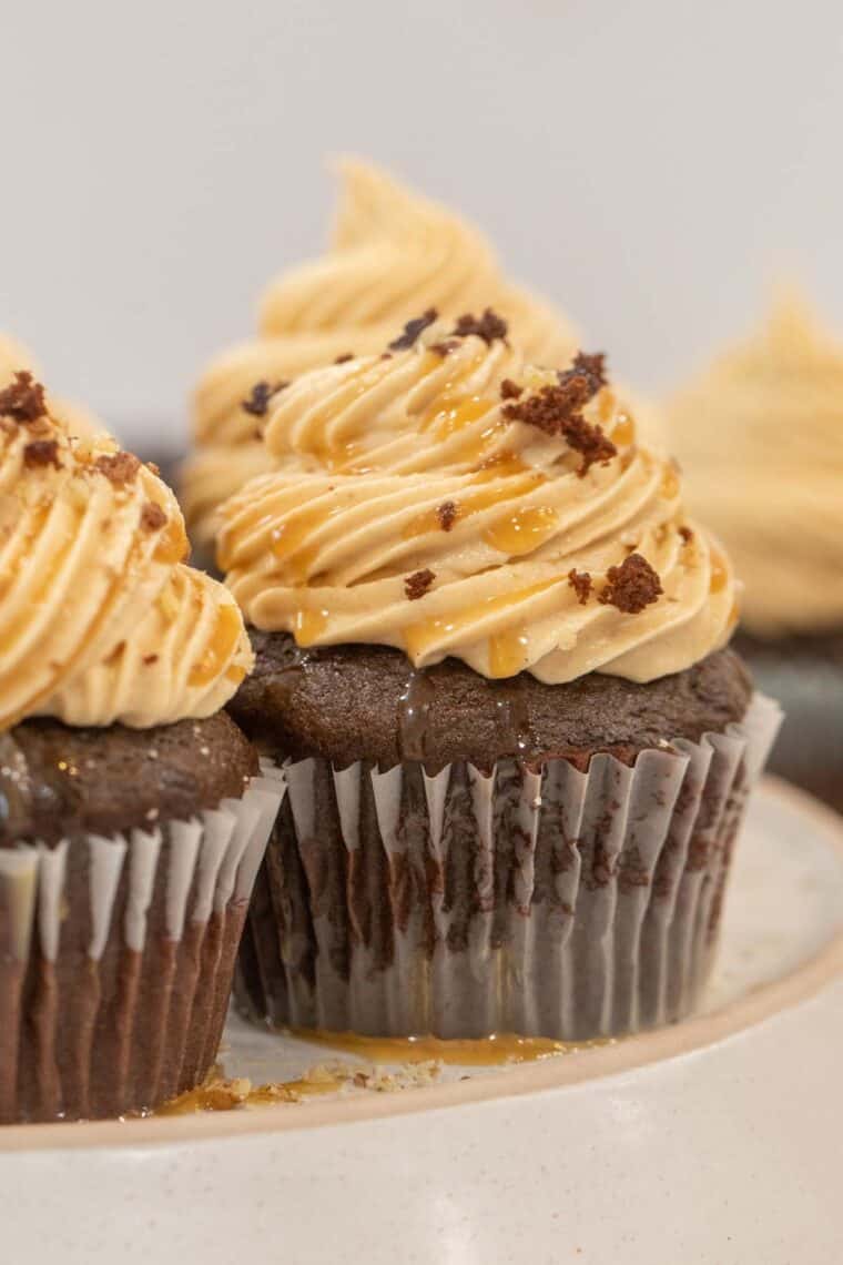 Chocolate peanut butter cupcakes topped with caramel drizzle. 