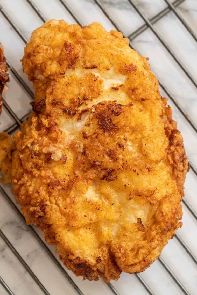 Crispy fried chicken on a cooling rack. 