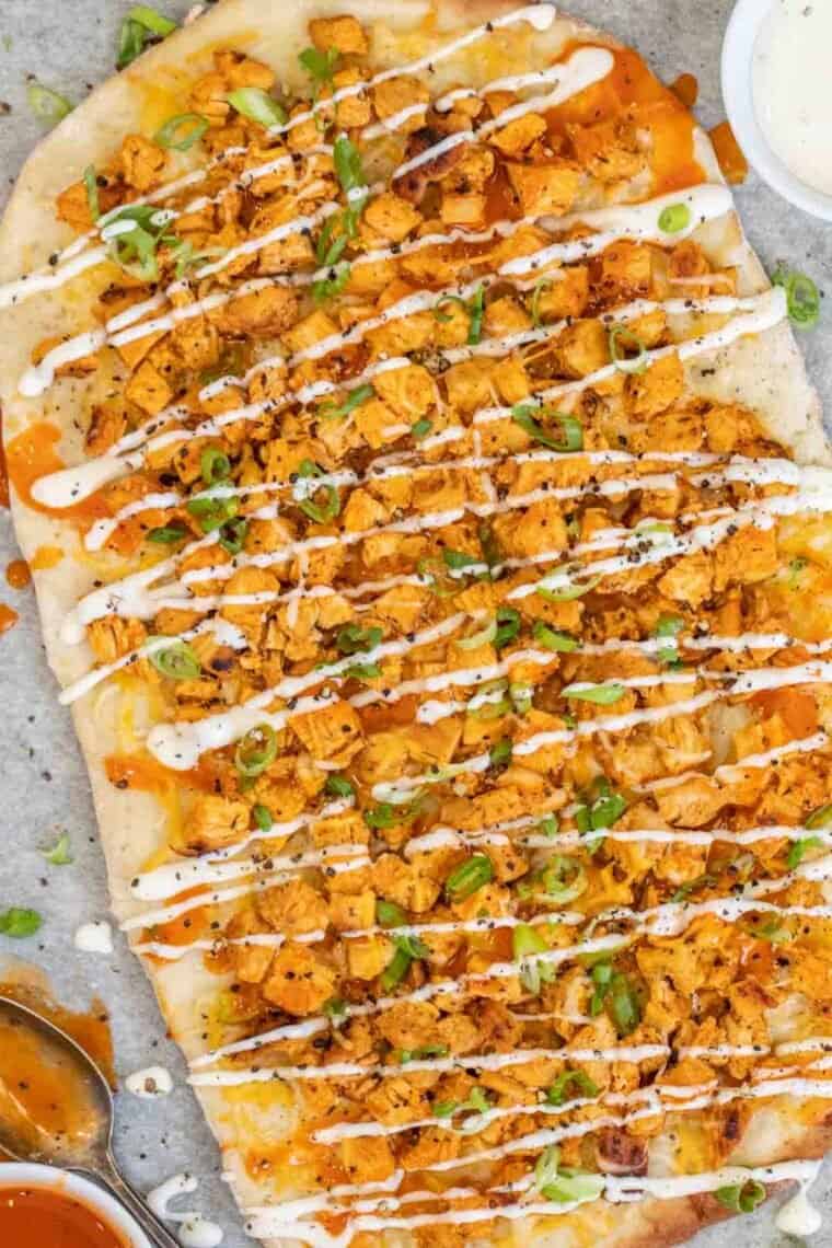 Flatbread pizza with buffalo chicken and cheese drizzled with Ranch and green onion. 