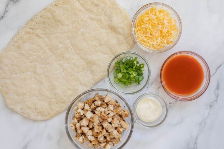 All the ingredients needed for buffalo chicken flatbread. 