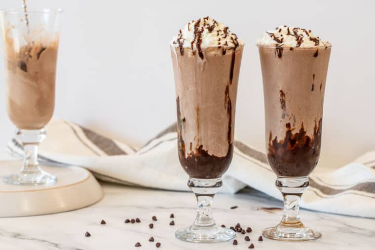 Thee milkshakes with chocolate chip morsels. 