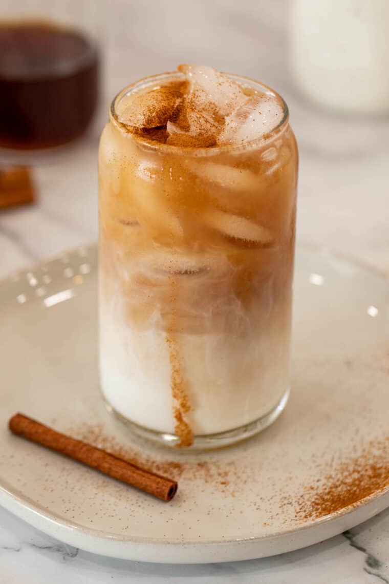 Close up of iced Chai Latte with ice and cinnamon spice on top.