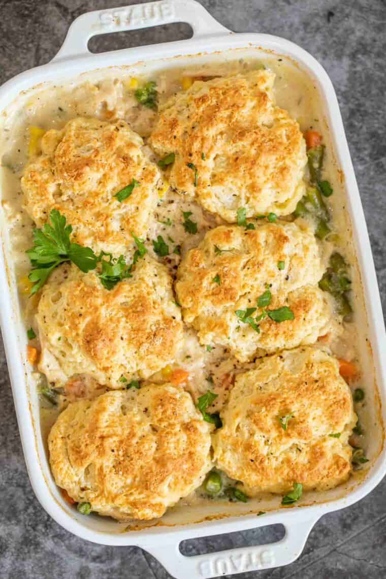 Chicken pot pie in serving bowl topped with biscuits.