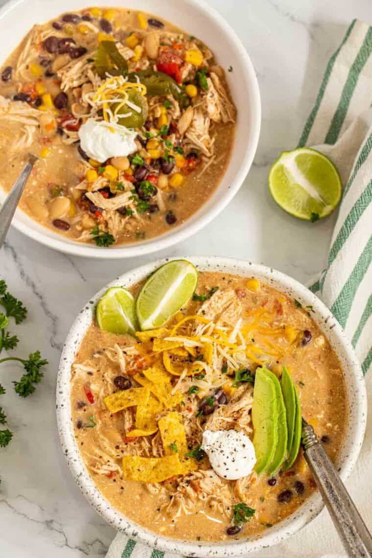 Instant pot chili recipe served in a bowl topped with sliced avacado and lime.