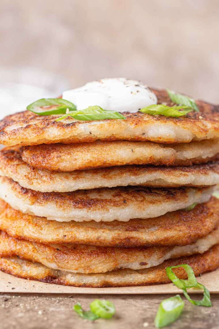 Savory pancakes stacked with sour cream. 