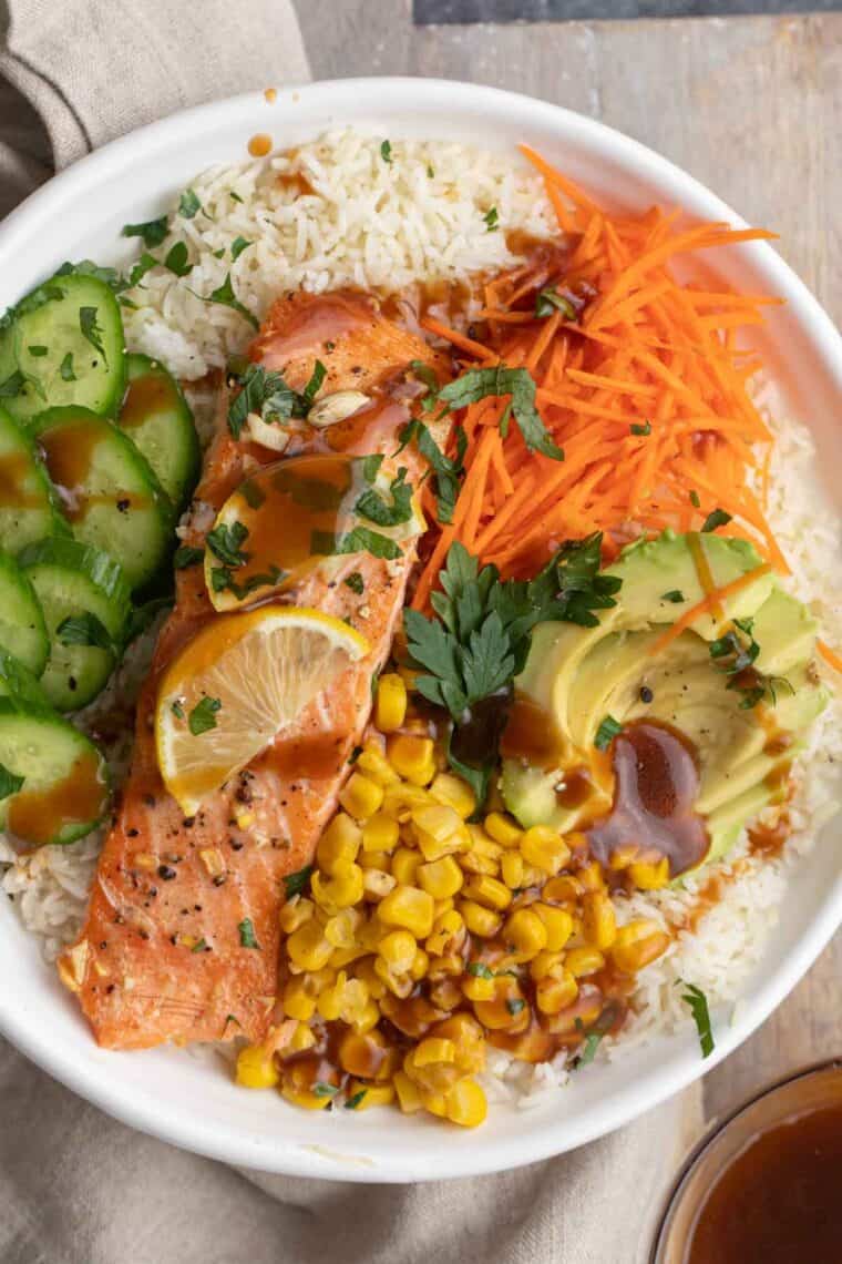 Close up of salmon bowl recipe drizzled with teriyaki sauce.