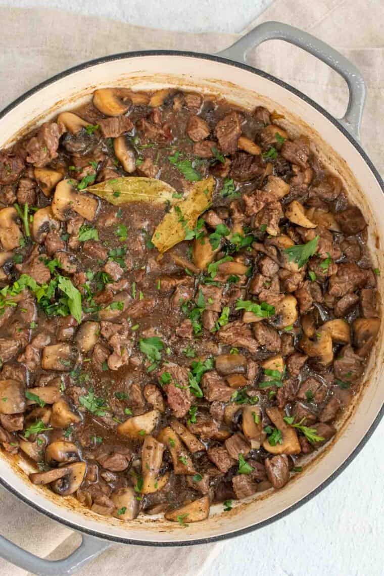 Close up of beef gravy with mushrooms.