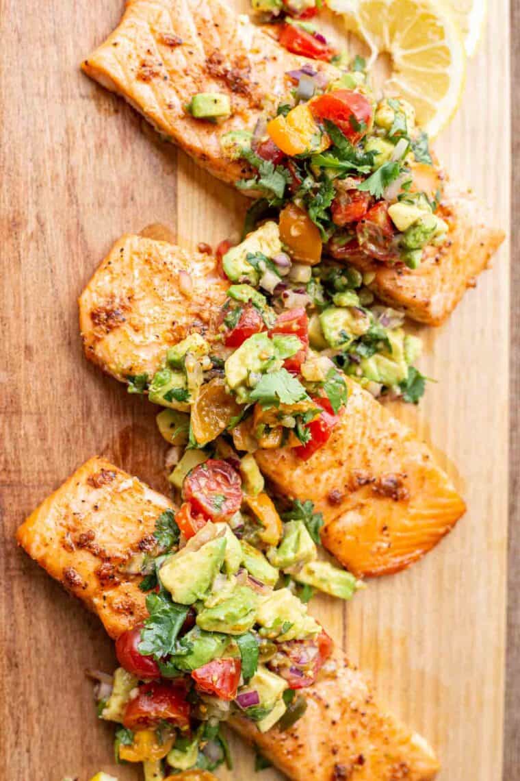 Baked salmon filets toped with fresh avocado salsa. 