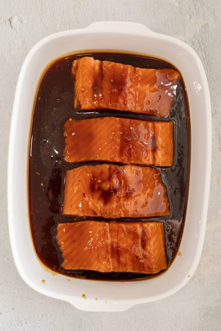 Salmon drenched in teriyaki sauce ready to be baked.