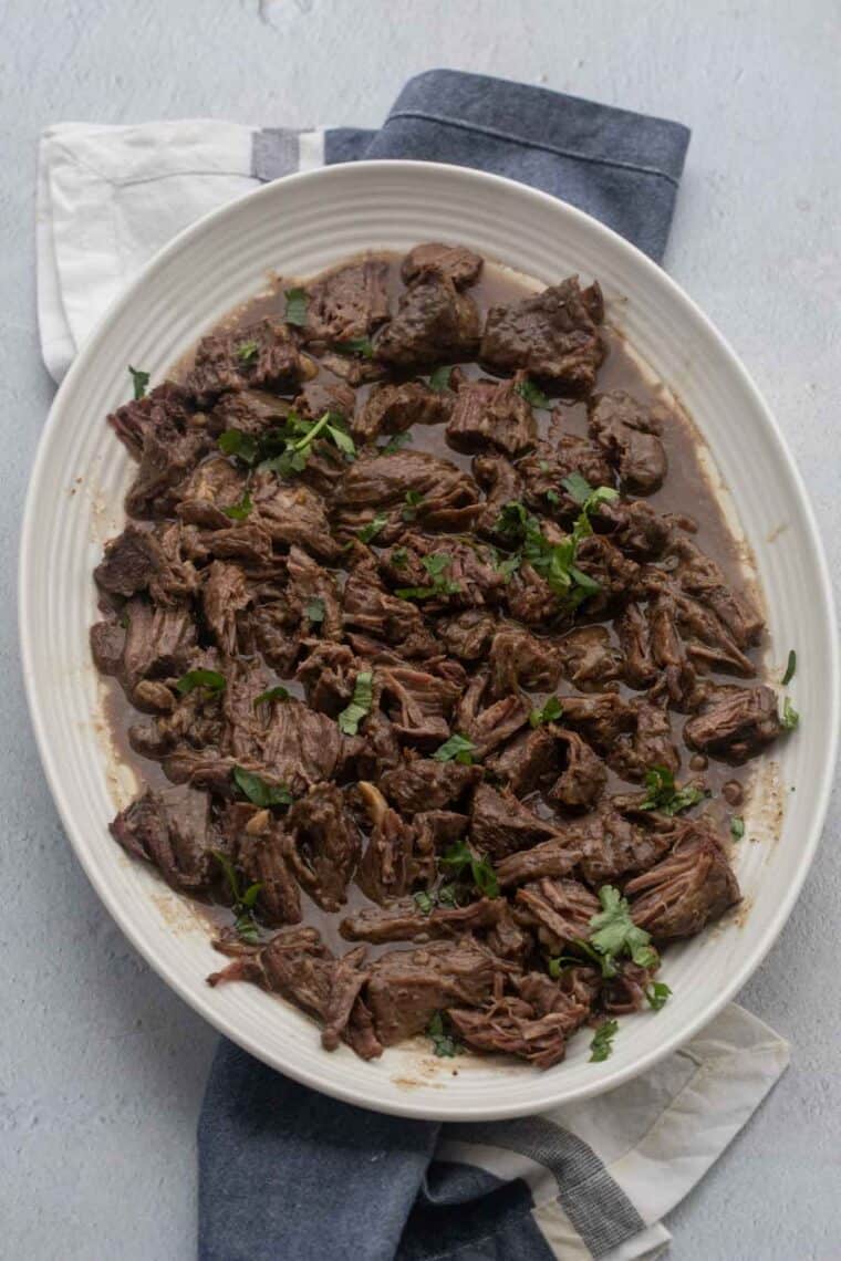 Close up of cooked beef in a serving plate.