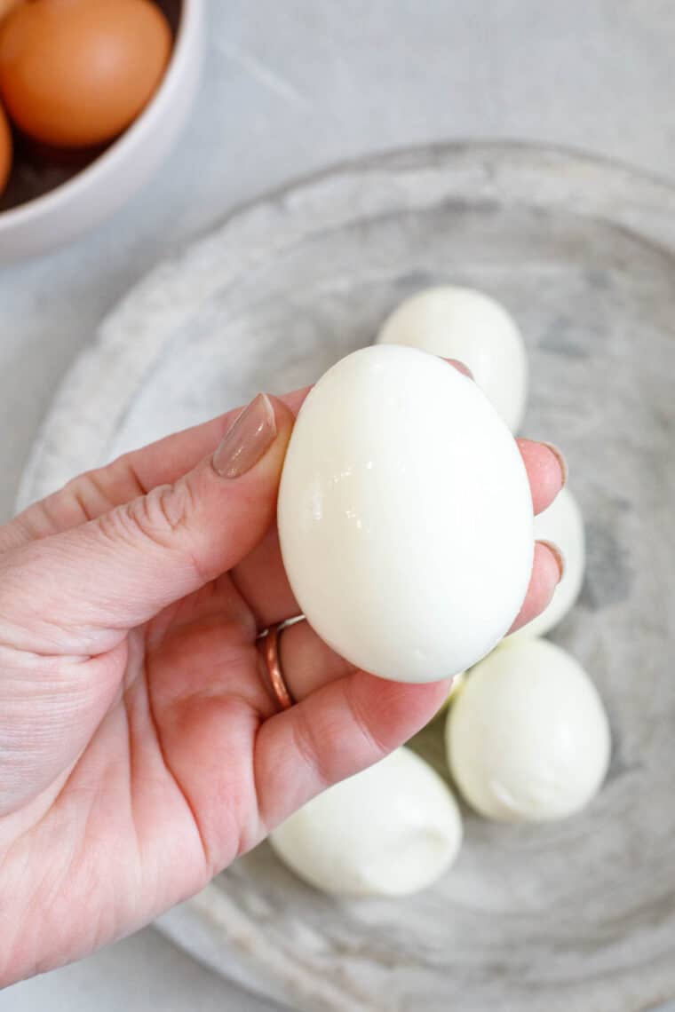 Up close picture of finished hard-boiled egg held in hand.