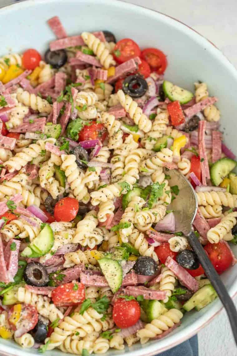 Pasta with vegetables, salami and dressing tossed