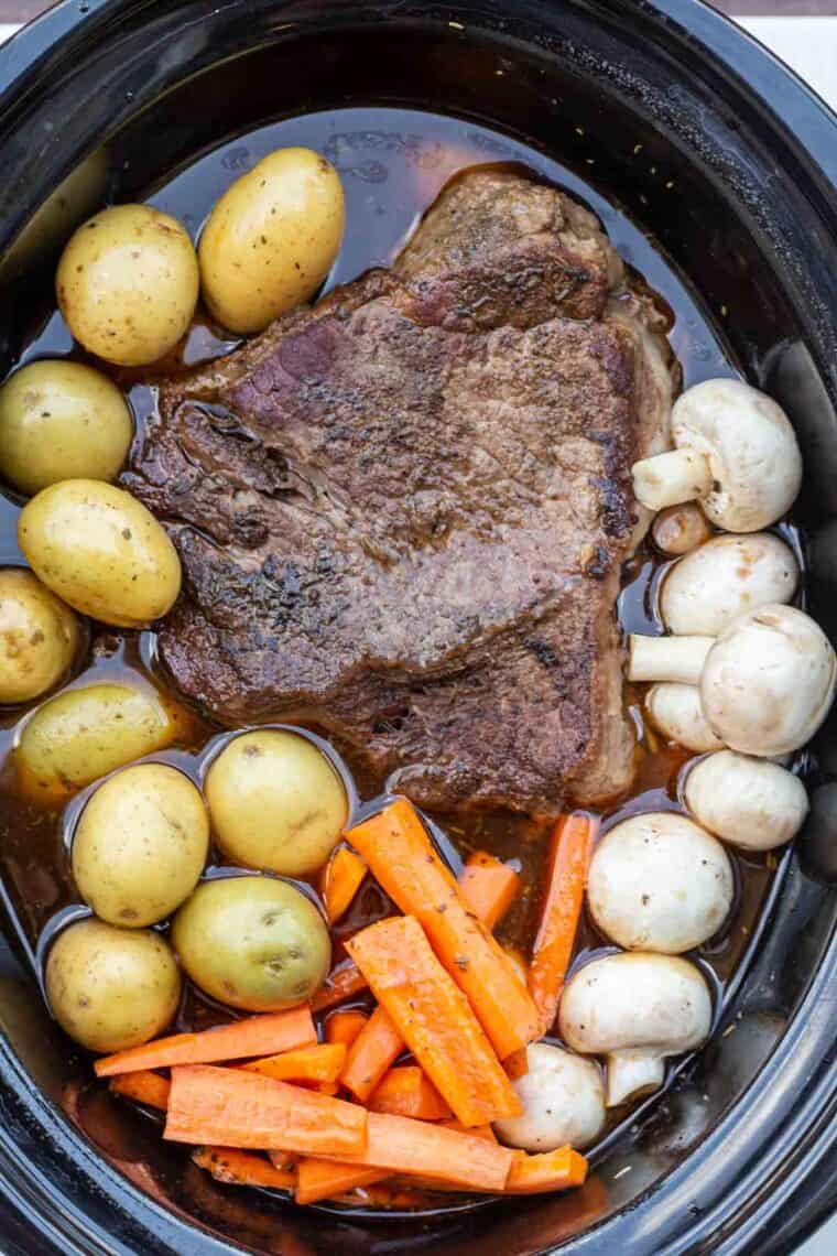 Pot roast in slow cooker before being cooked.