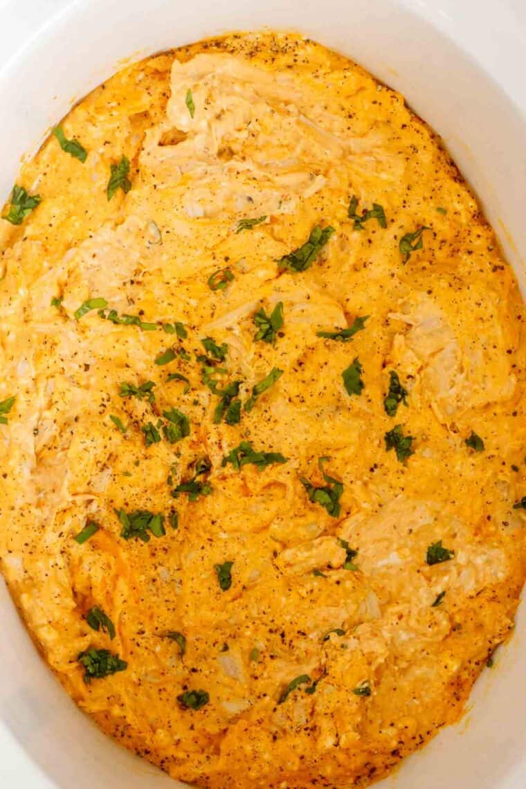A close up photo of finished buffalo chicken dip in crockpot.