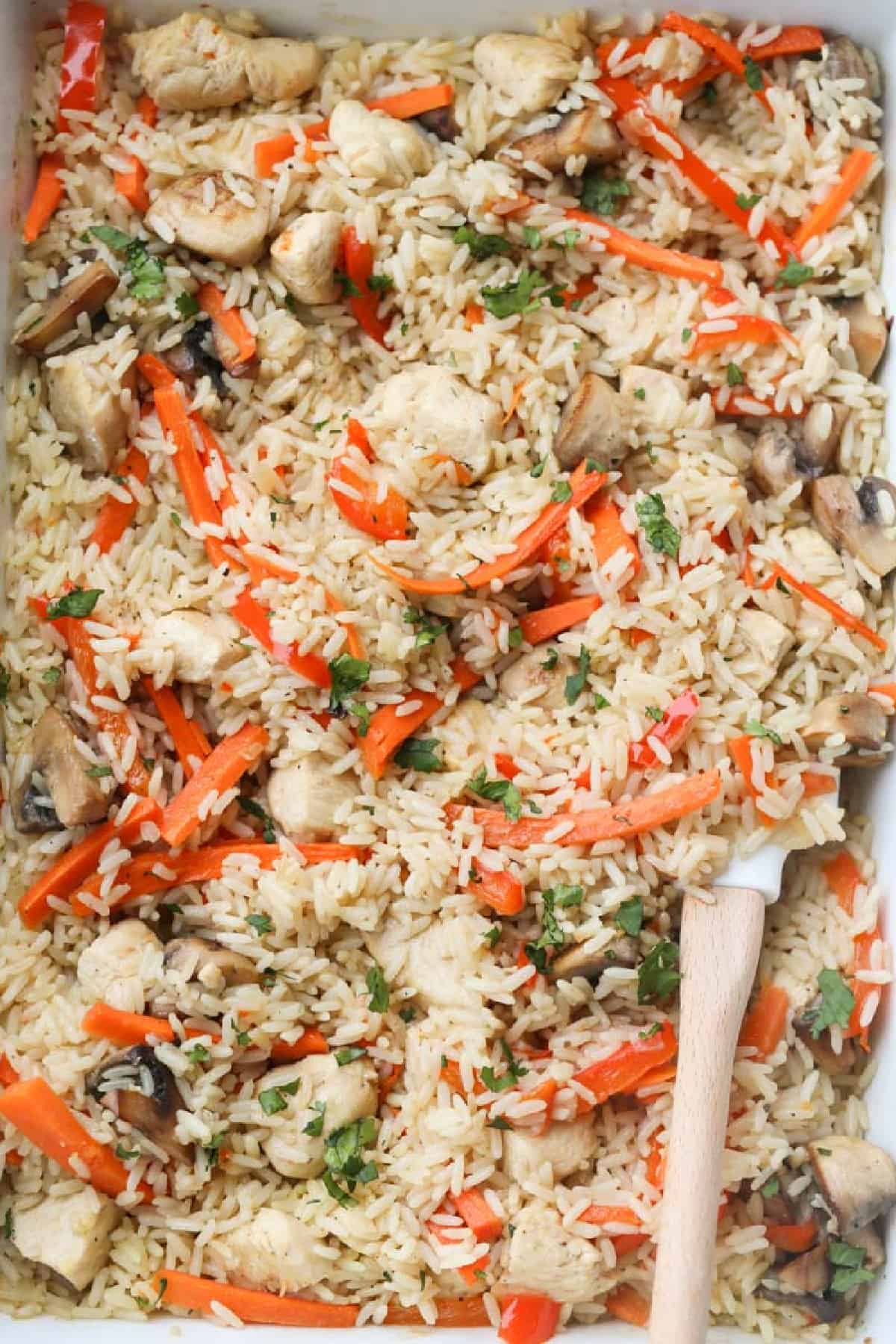 Baked chicken and rice with carrots and greens.