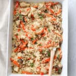 Square image of chicken and rice in a serving casserole dish.