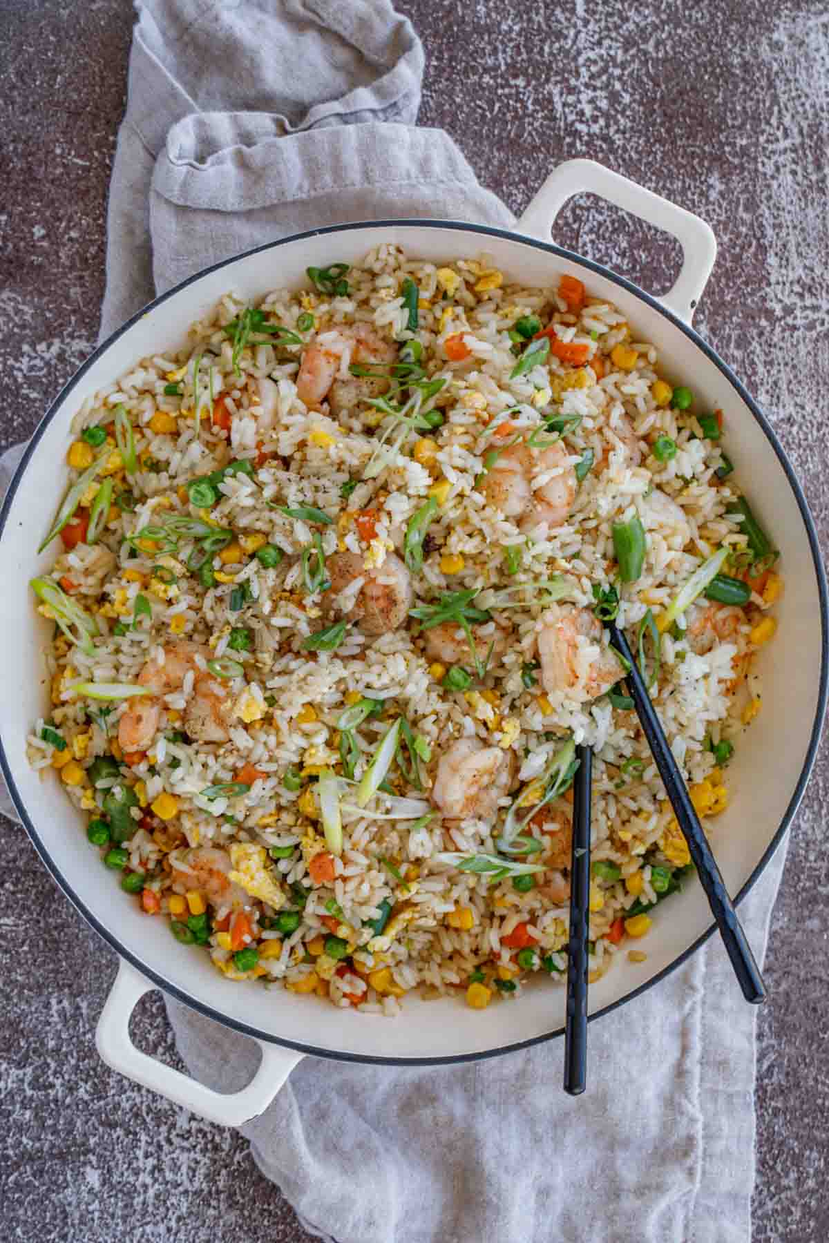 Shrimp fried rice in dutch oven with chopsticks.