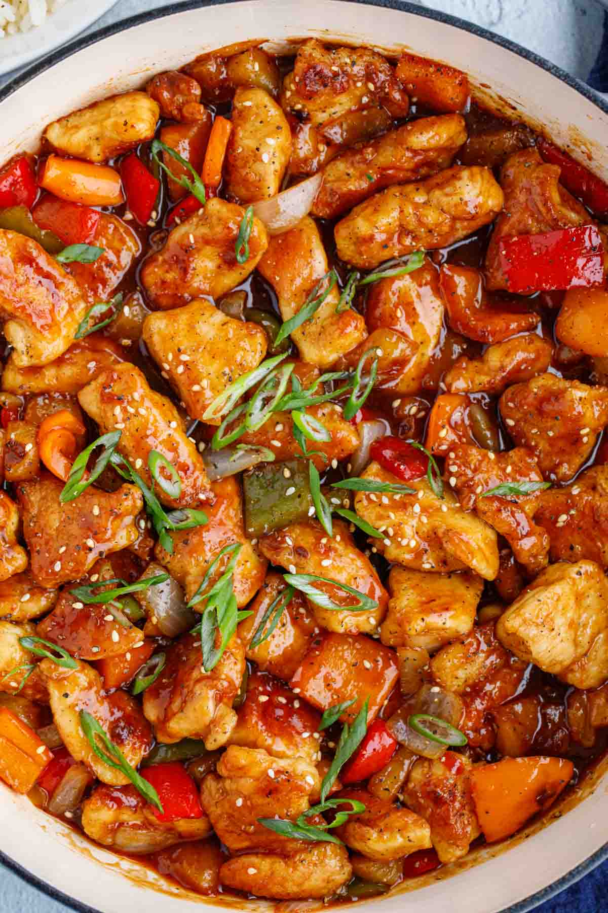 Up close picture of sweet and sour chicken recipe inside dutch oven.