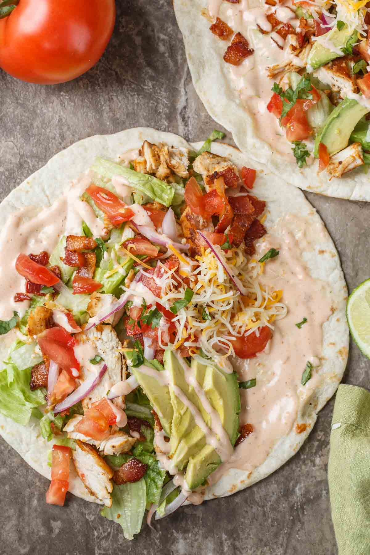 Chicken wrap with chicken, cheese, lettuce and bacon and Ranch on a flour tortilla.