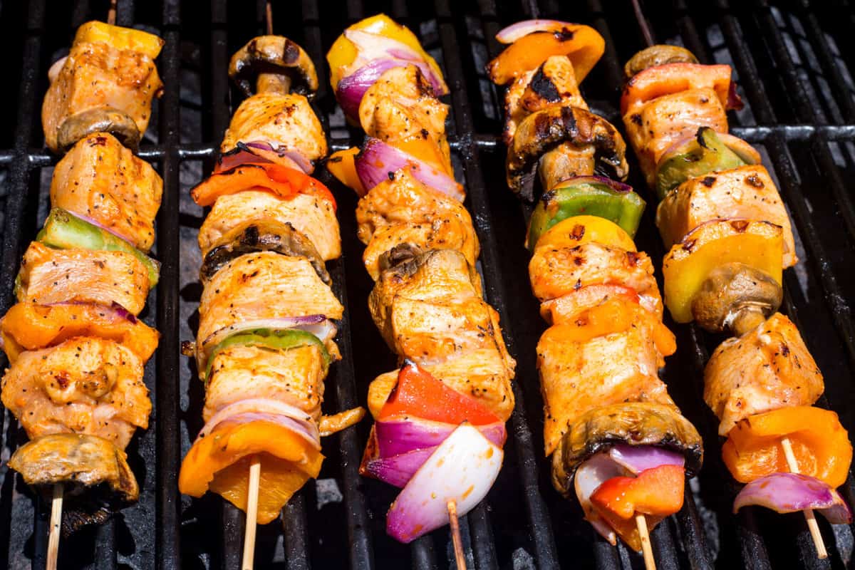 Chicken kebabs with vegetable on the grill.