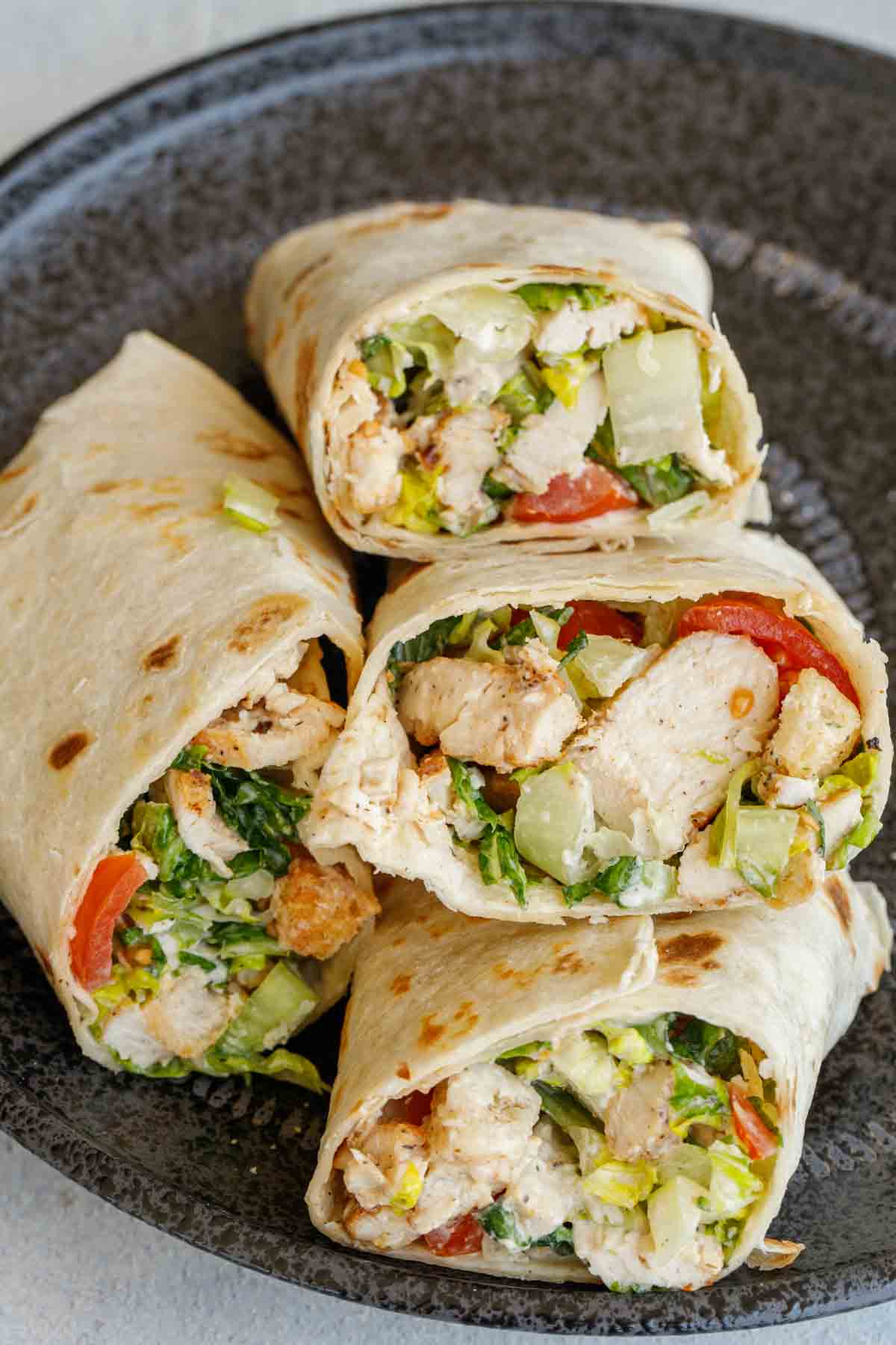Close up of chicken wrap cut in half and stacked.