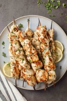 Chicken kabobs on skewers plated.