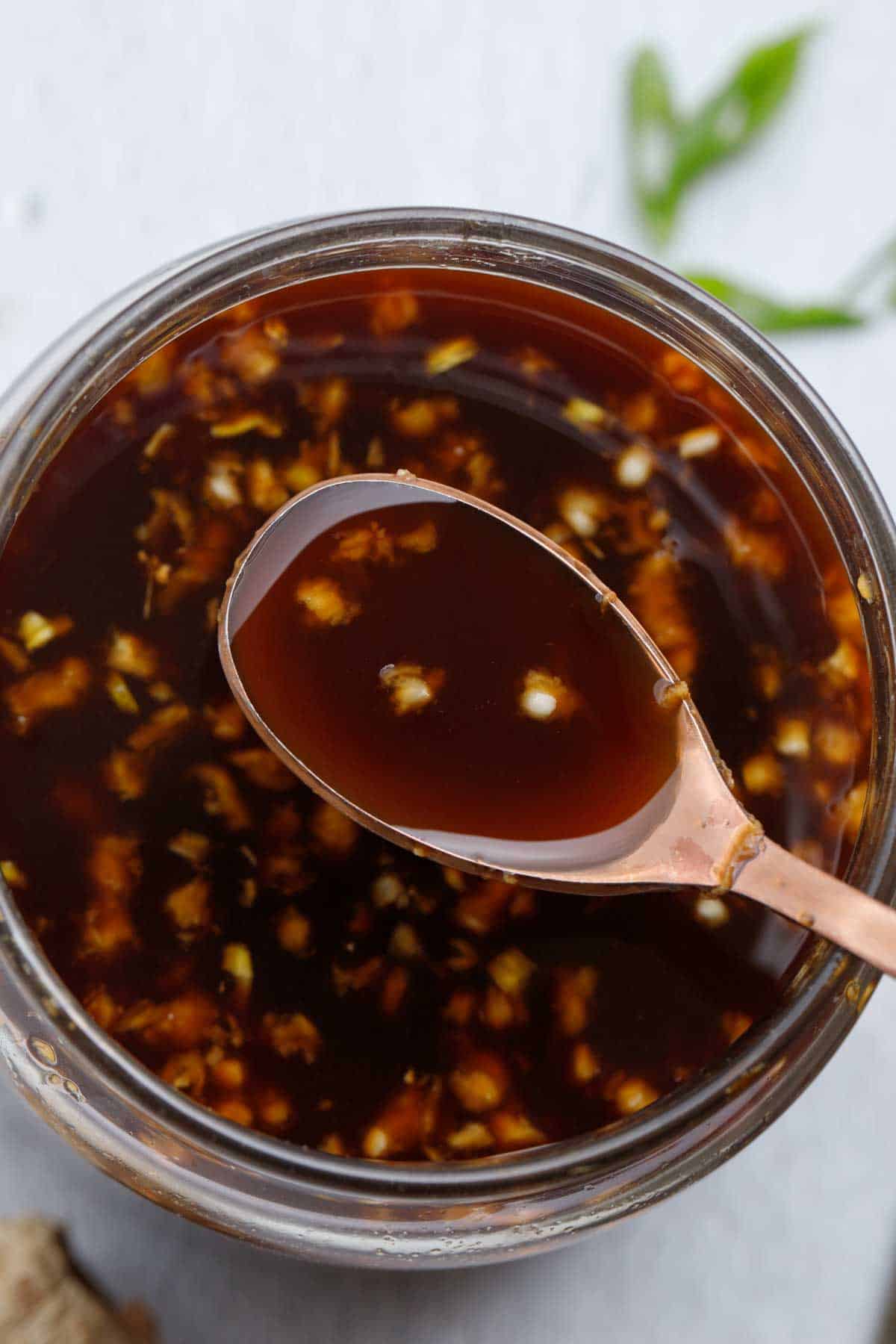 A close up of hibachi ginger sauce beign scopped with a spoon.