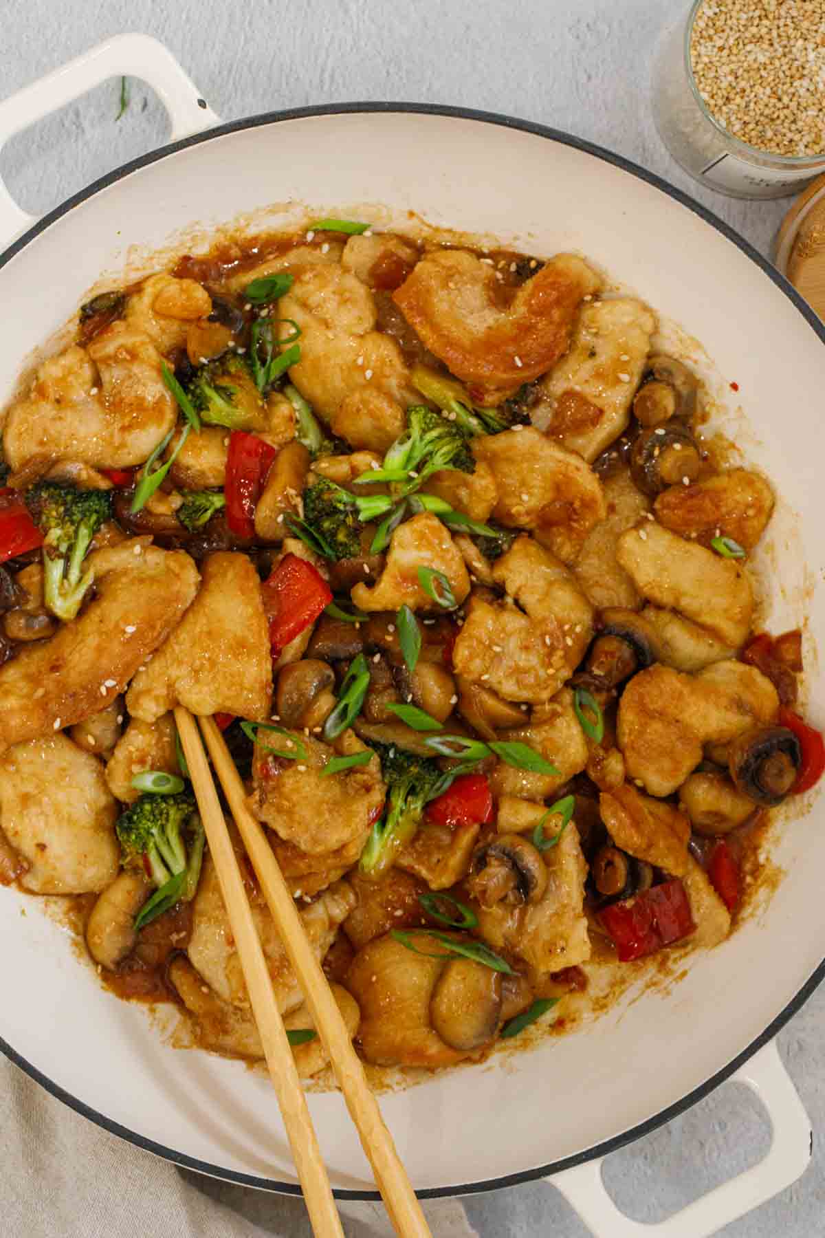 Chinese inspired Chicken Hunan in a skillet with chopsticks.