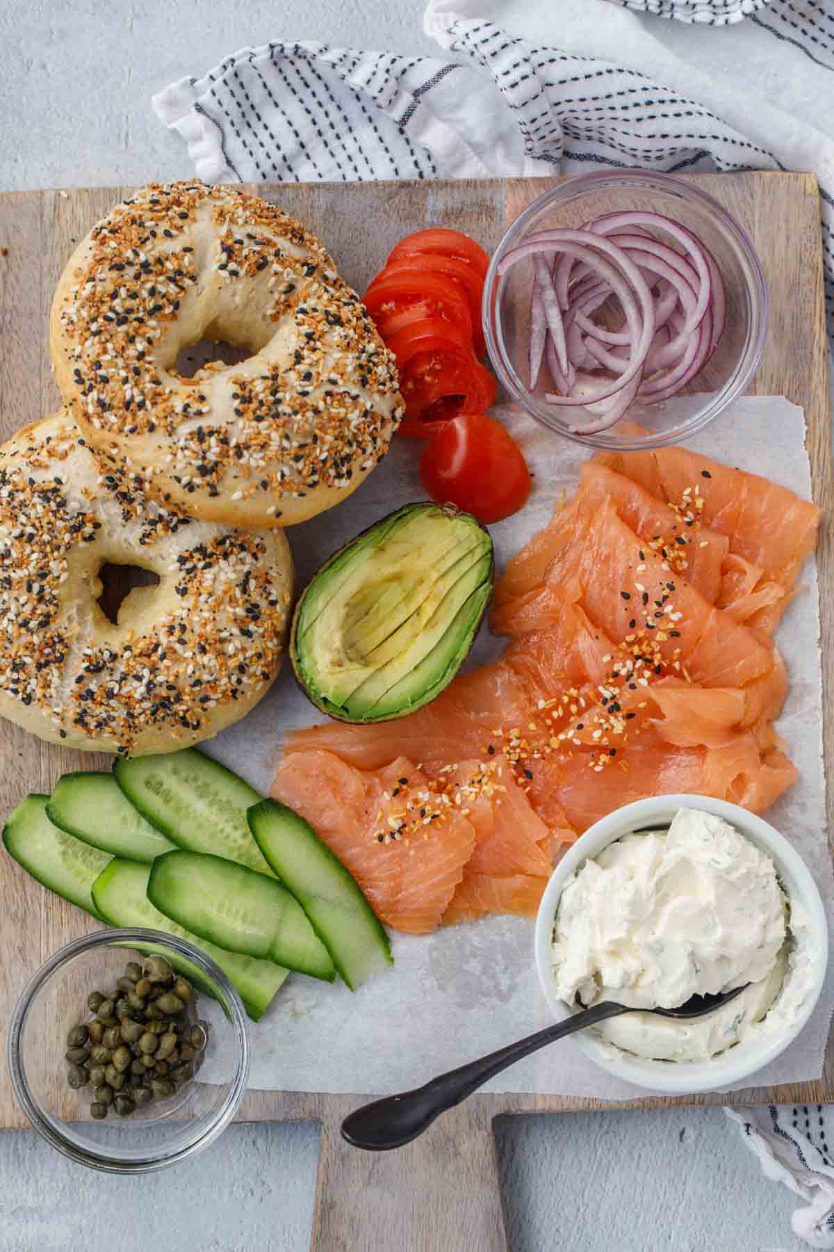 All ingredients for salmon bagel on a charcuterie layout.