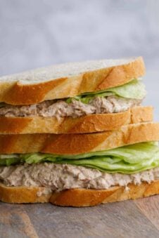 Close up of tuna sandwiches stacked.