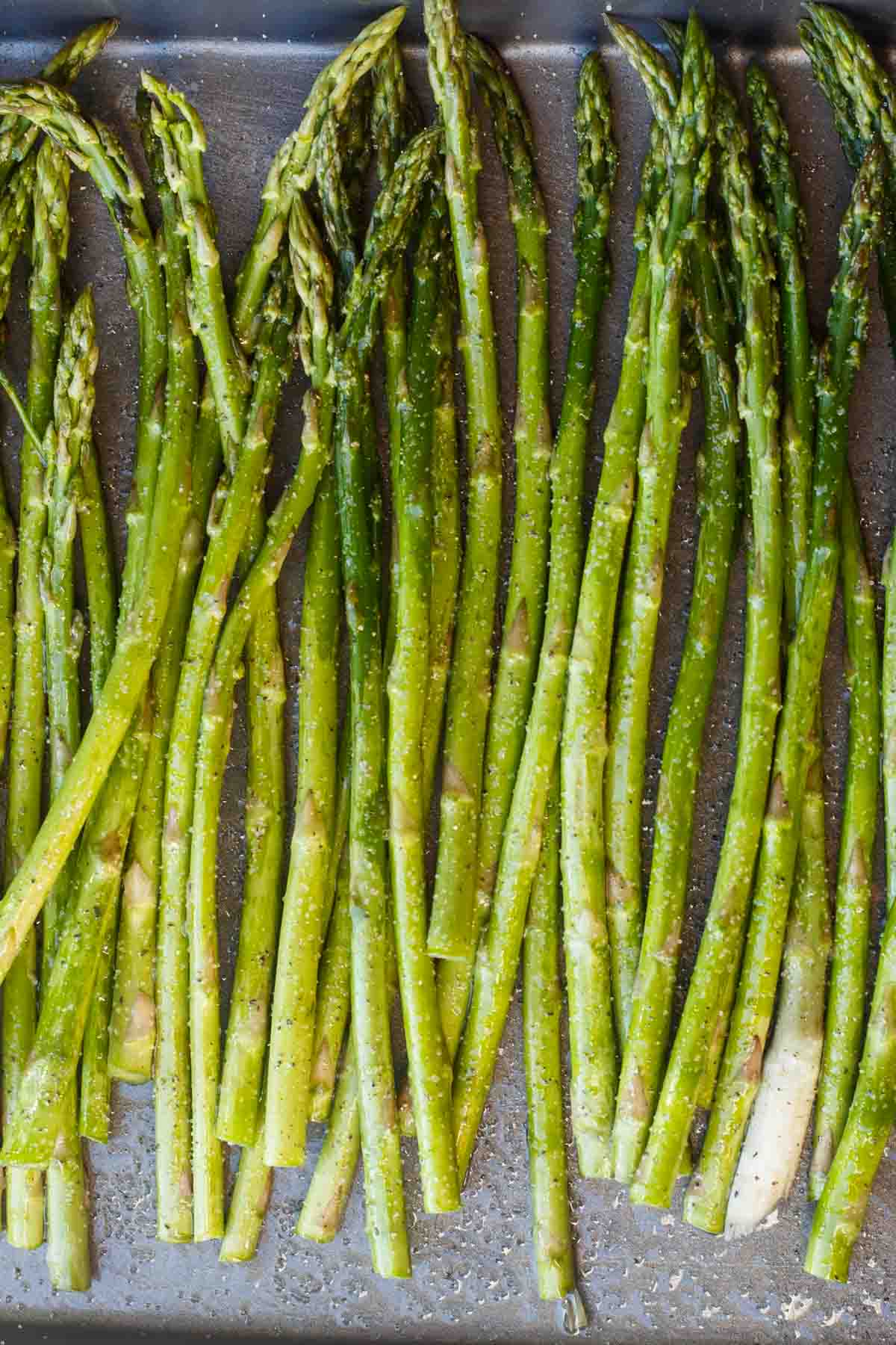 Close up of asparagus in a baking sheet.