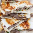 Steak quesadillas stacked on top of eachother.