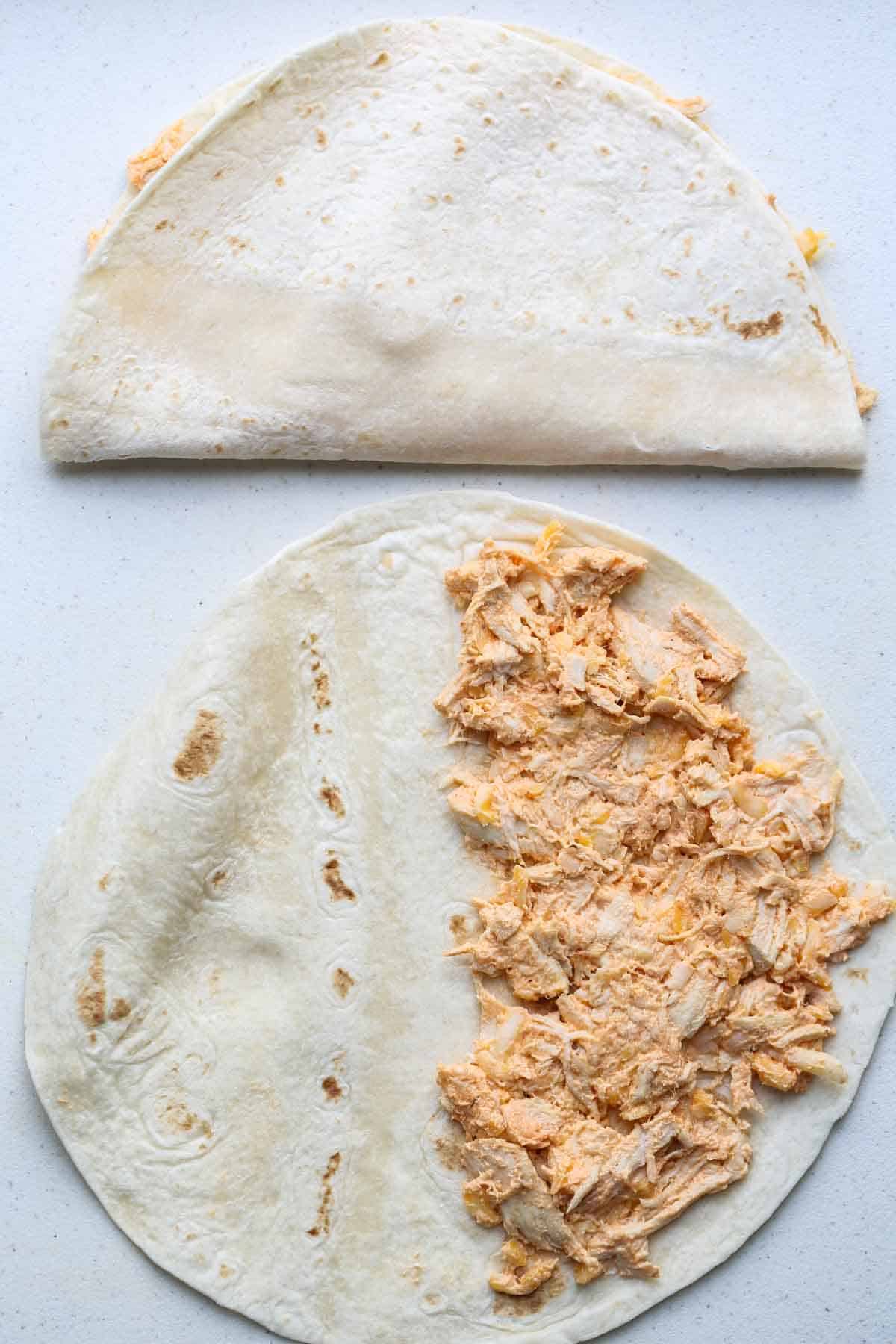 A tortilla with the spread on half of it. 