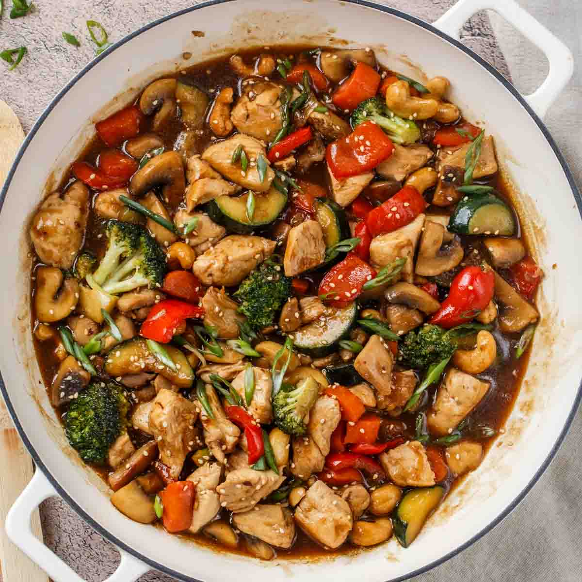 The skillet, now containing the sauce with  the chicken, and vegetables. 