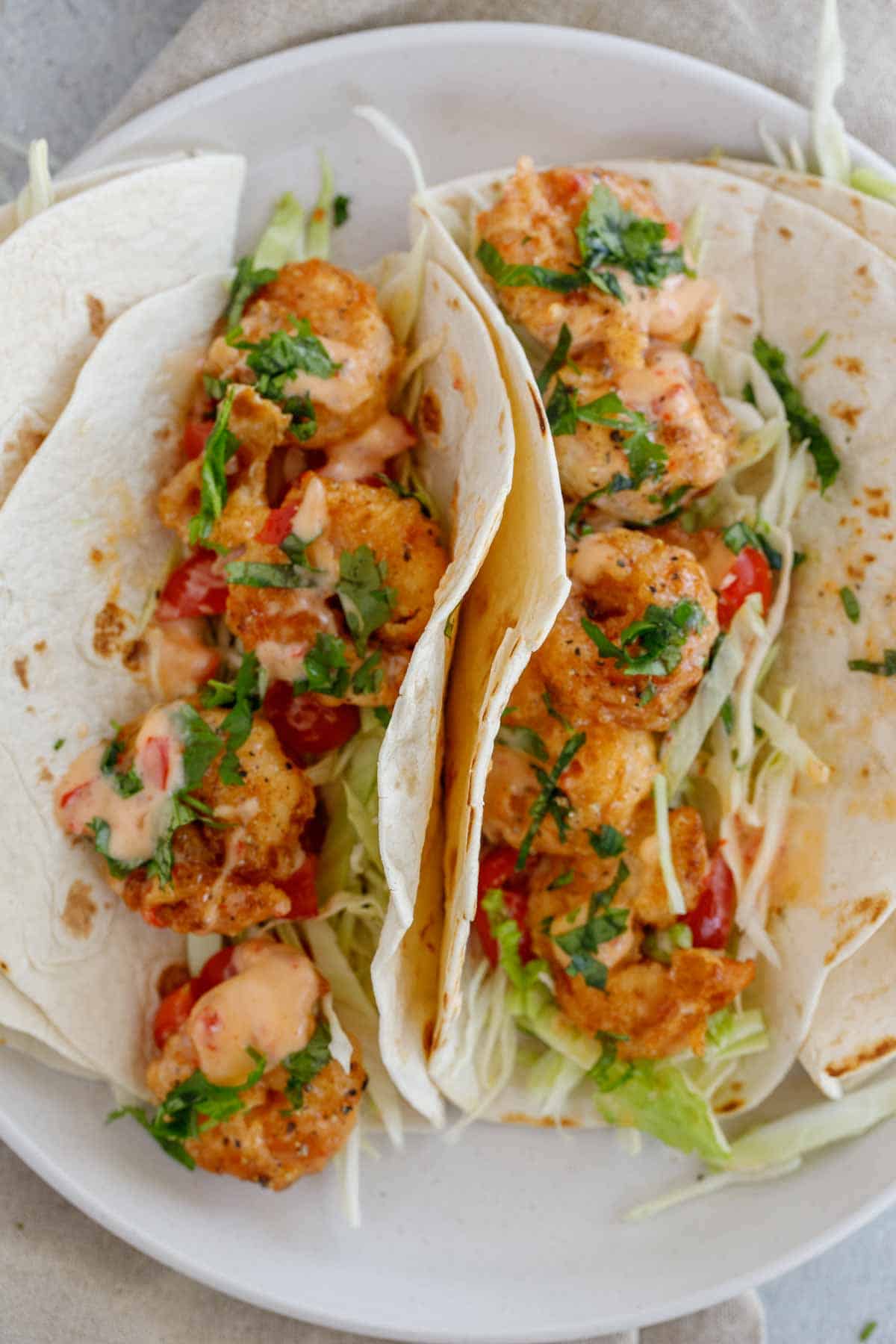 Bang bang shrimp tacos next to each other