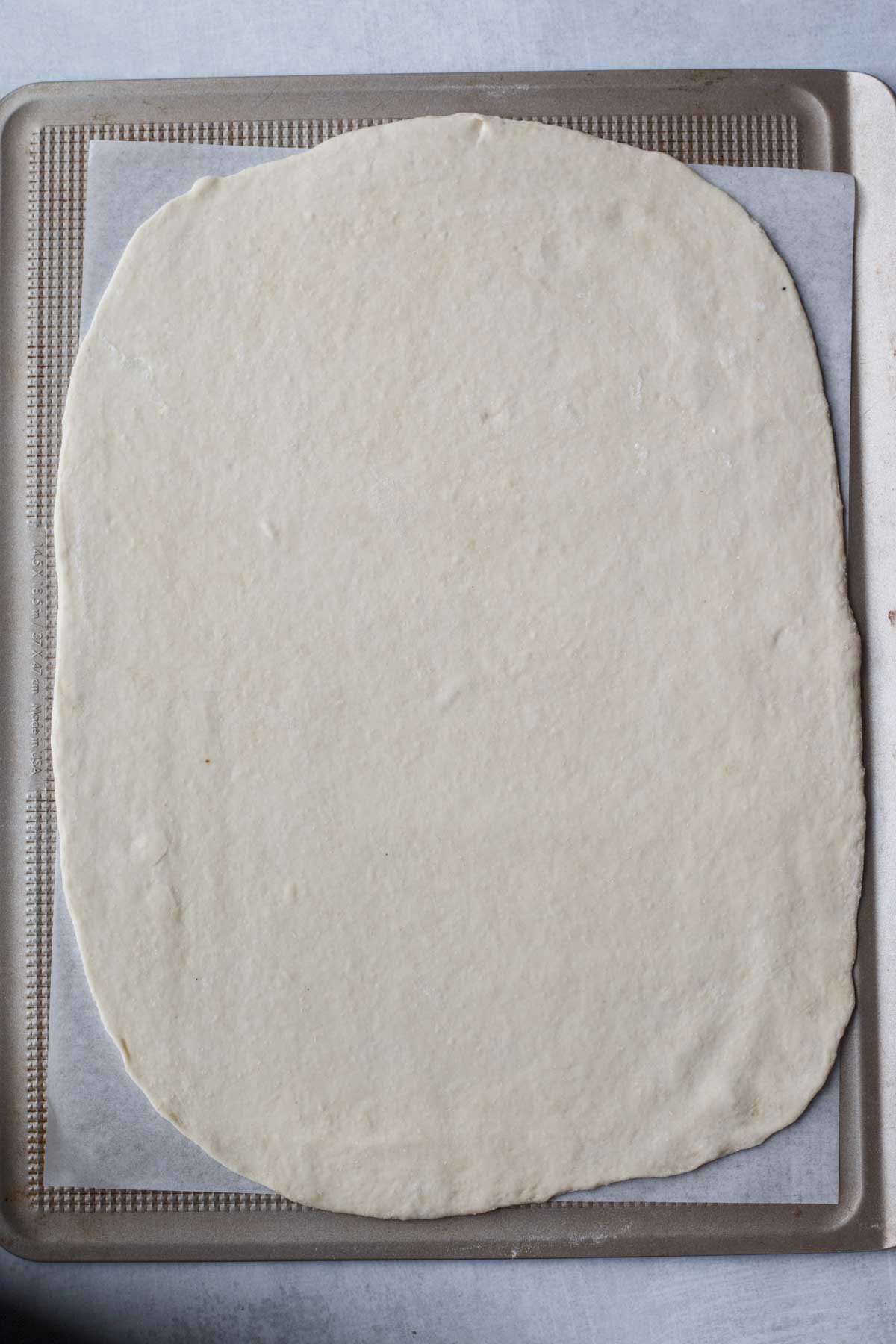 A sheet pan with rolled out dough. 