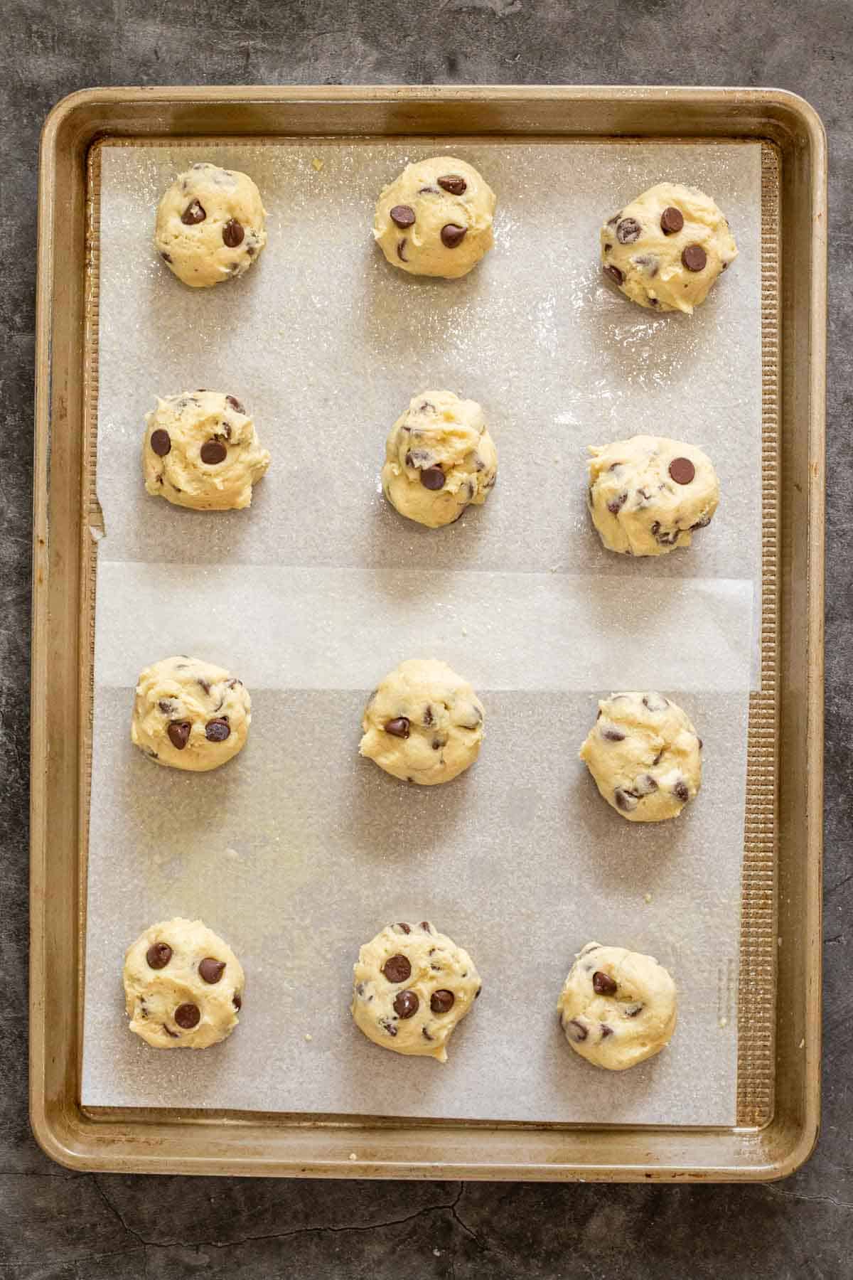 Raw cookies arranged on a baking sheet.