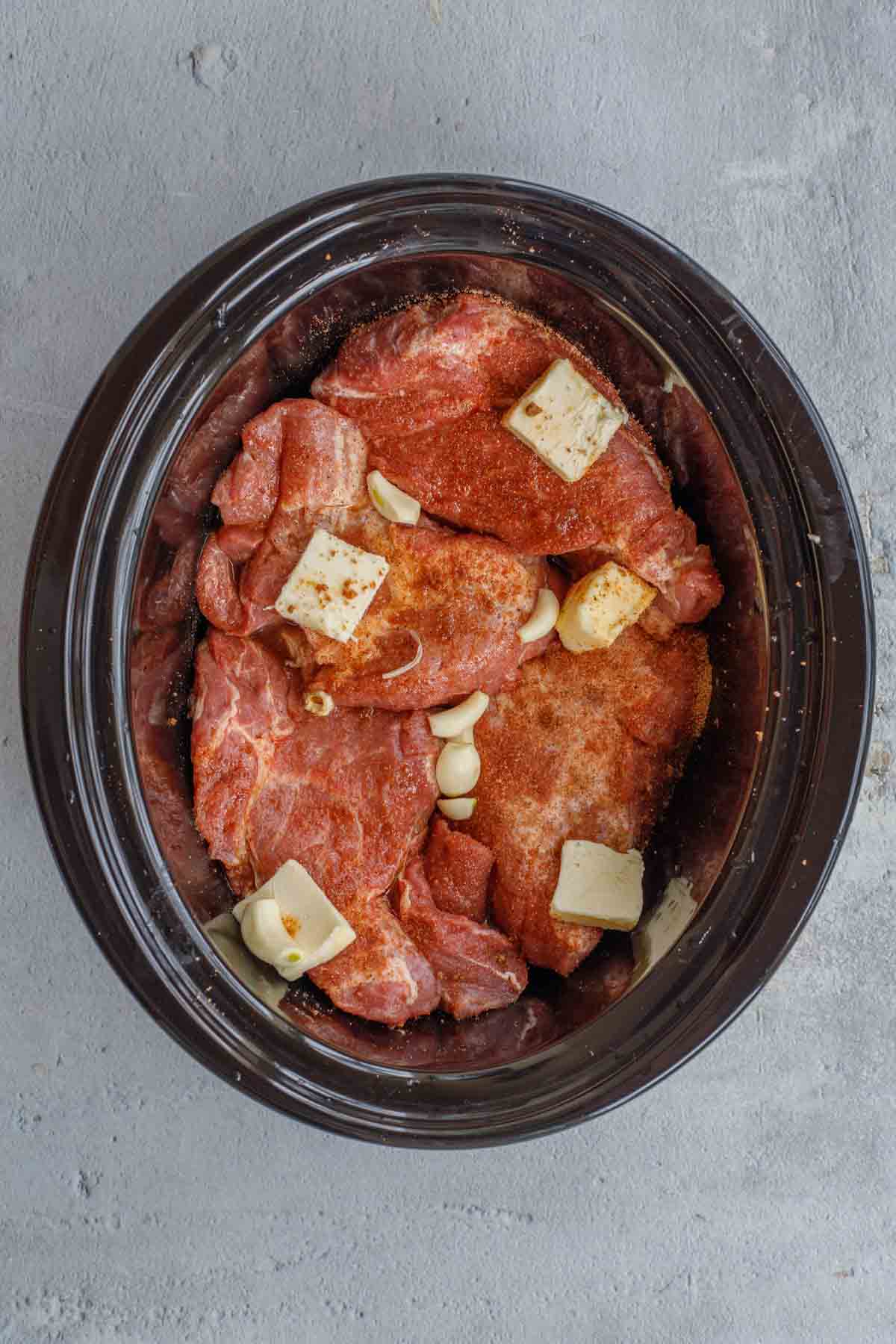 The crockpot with the meat and butter. 