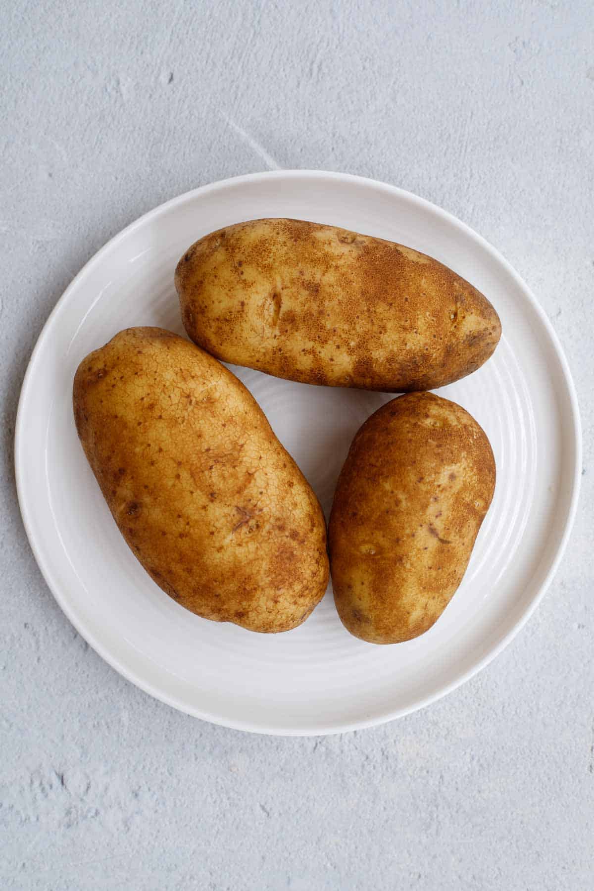 Russet potatoes on a plate. 