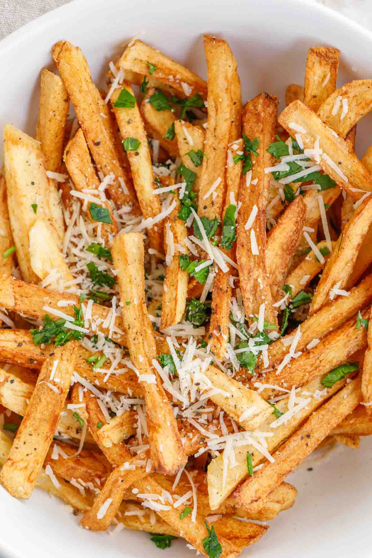 Fries topped with parmesan and fresh parsley. 