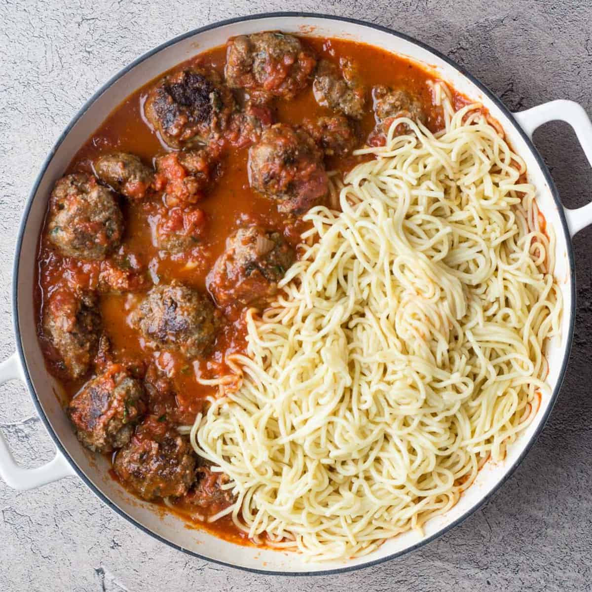 The meatballs are added to the sauce, along with the spaghetti. 