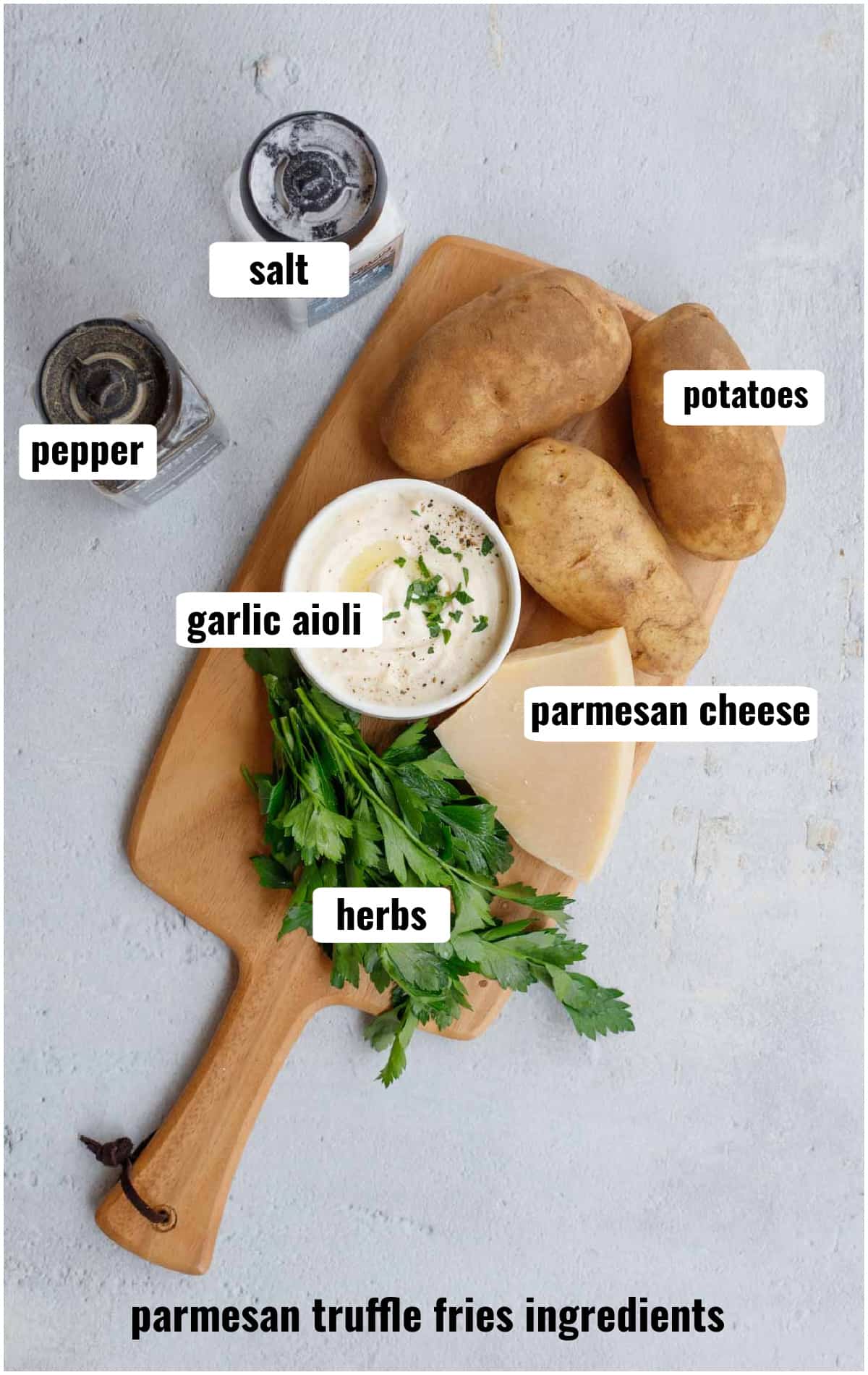 A cutting board with all the ingredients for parmesan truffle fries. 