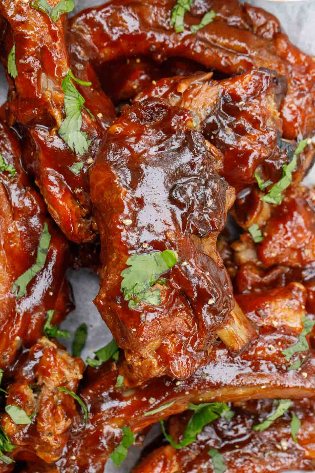 The pork barbecue ribs garnished with fresh cilantro. 