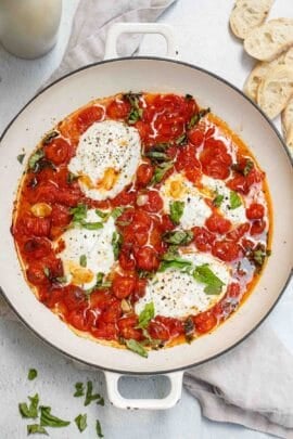 A pot of the roasted tomatoes, burrata, and fresh basil.