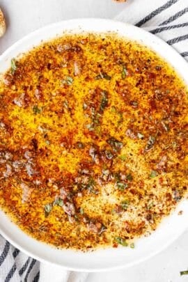 A white plate with the olive oil dip.