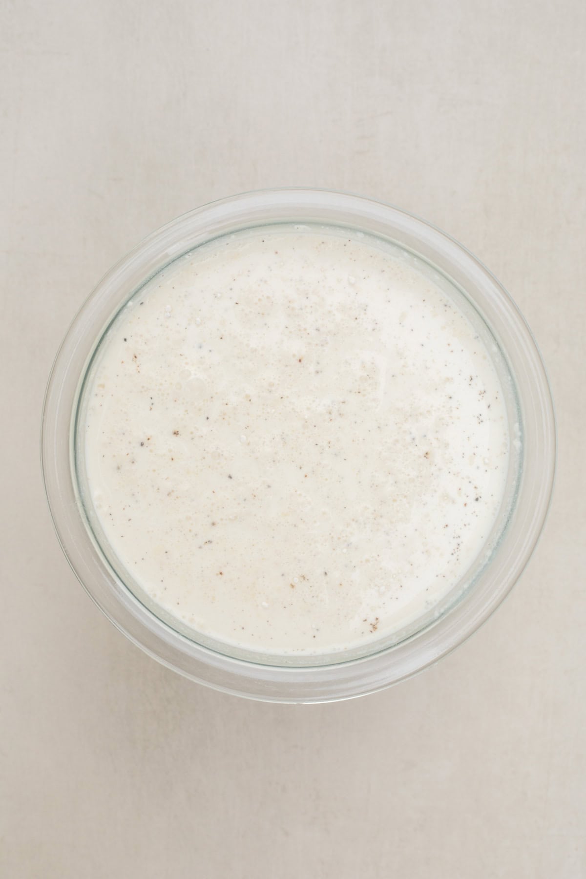 This cheesy chicken and rice casserole is the perfect baked comfort meal. A glass bowl with the broth mixture.