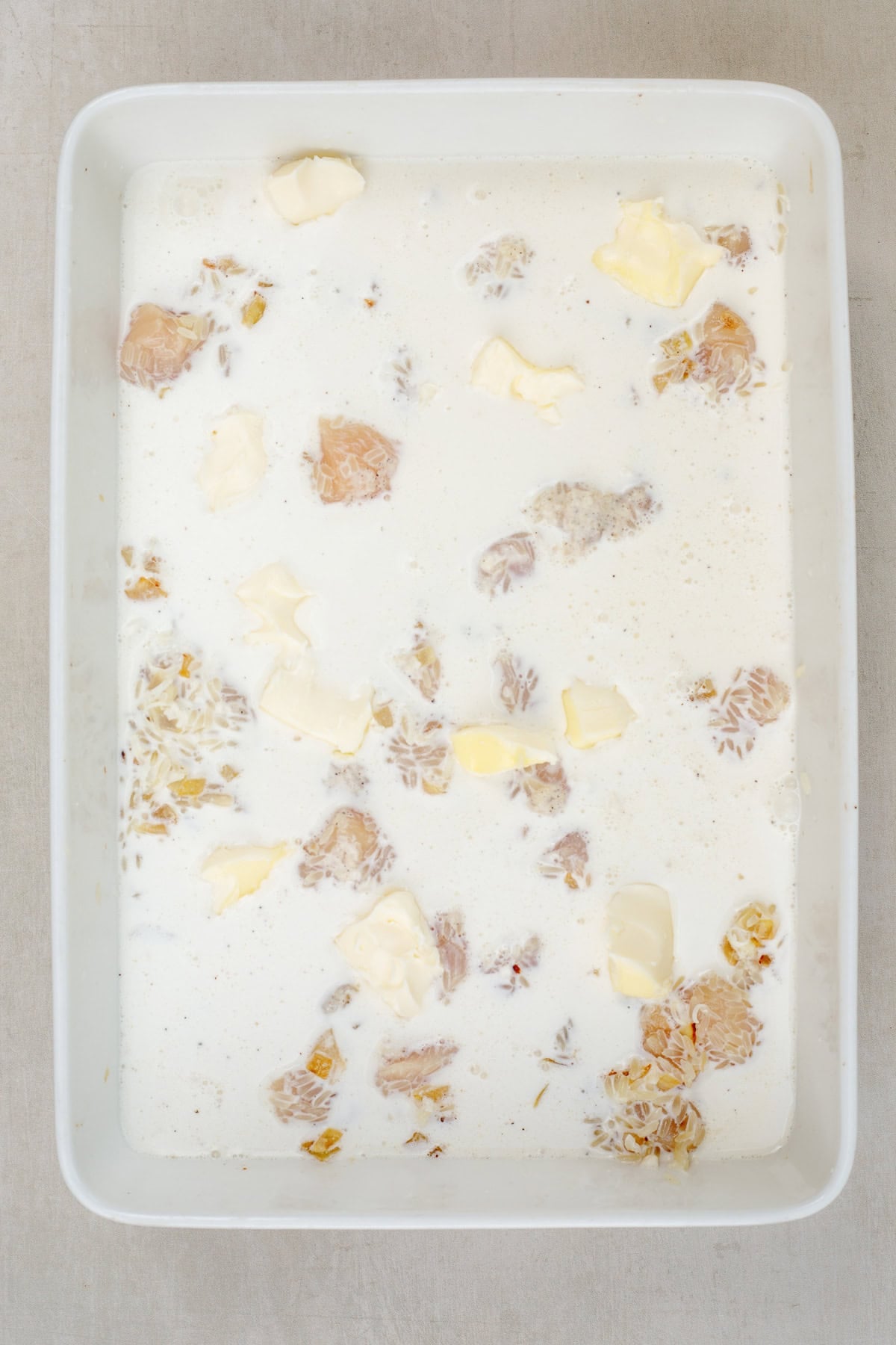 This creamy and cheesy chicken and rice casserole is a loaded comfort meal. A casserole dish with rice, chicken, and a creamy broth.