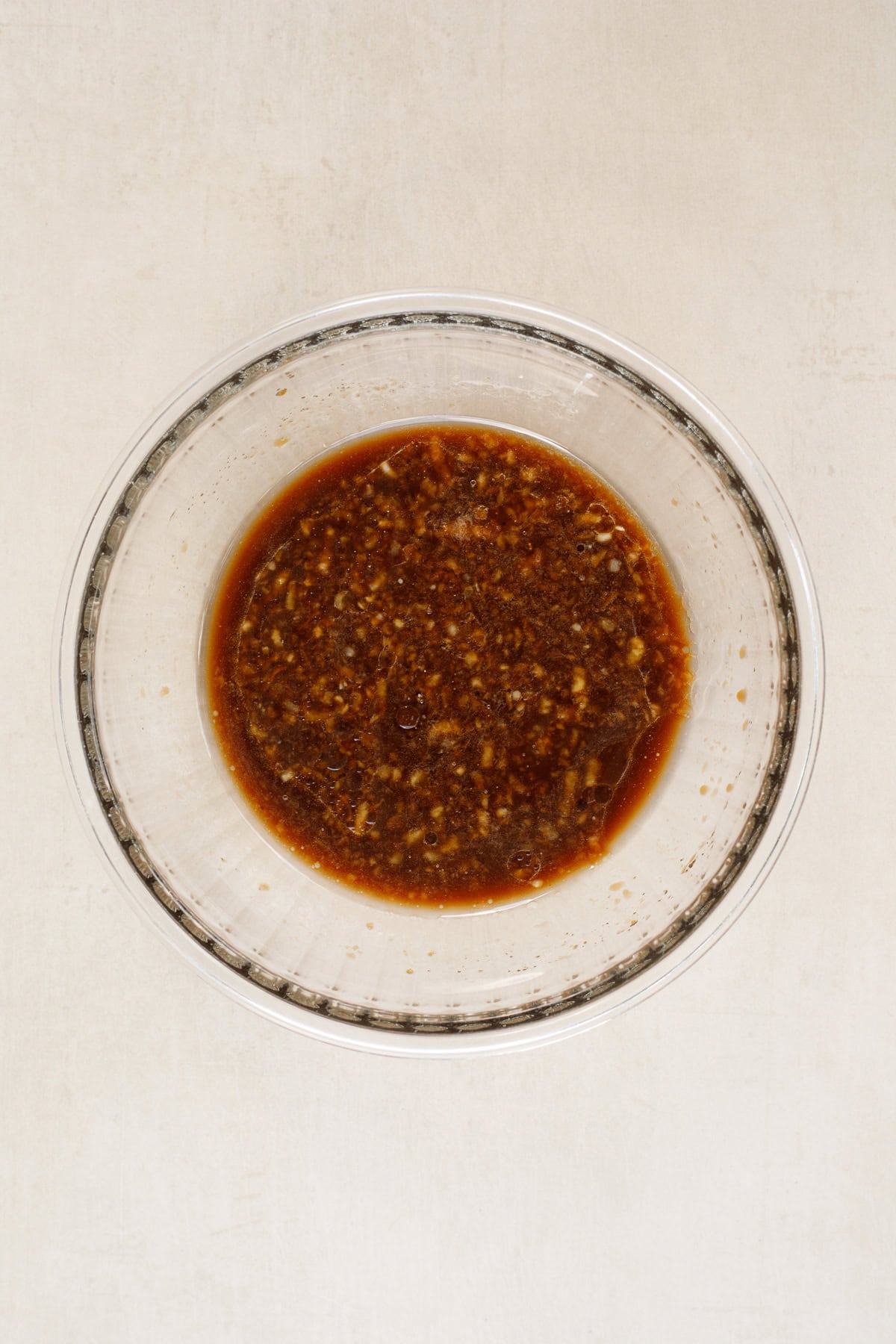 This easy hawaiian chicken sheet pan recipe makes the perfect 30 minute meal. A glass bowl with the hawaiin chicken stir fry sauce.