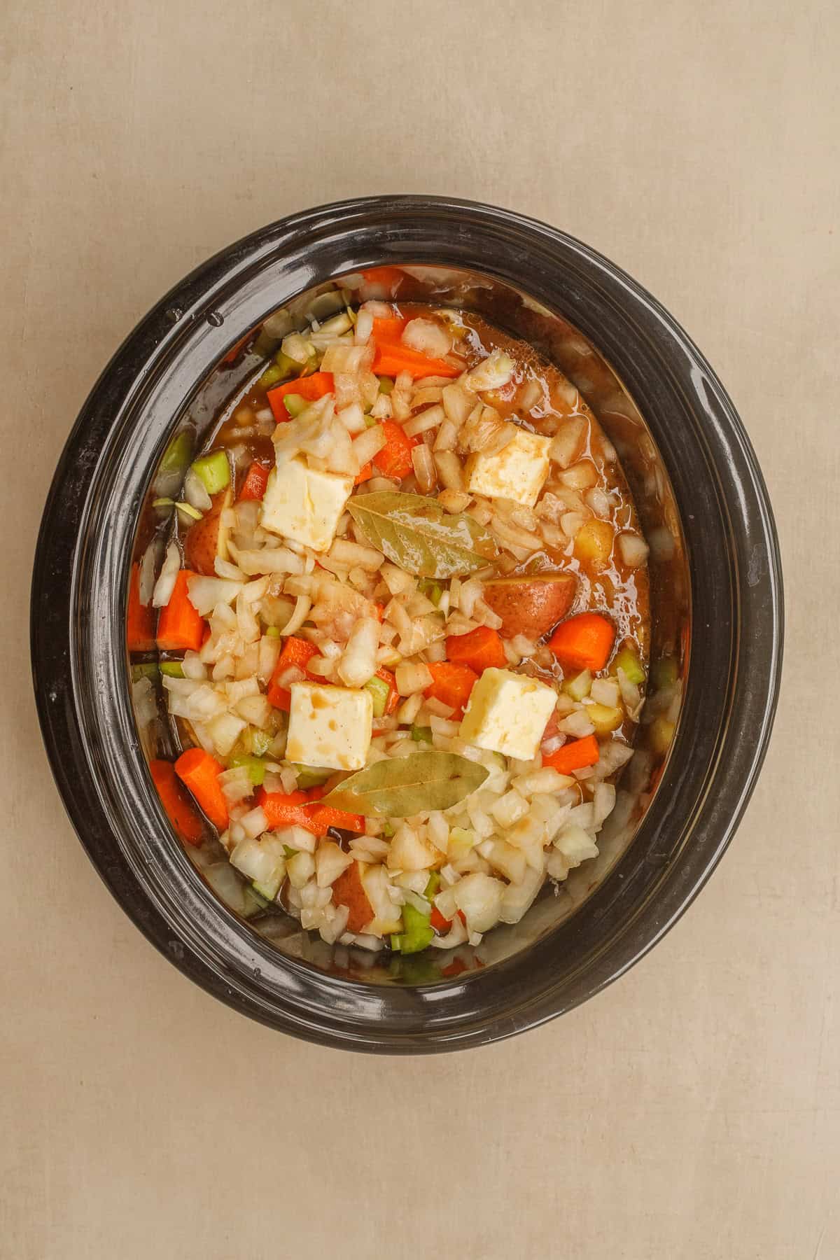 This easy beef stew recipe makes the perfect hearty dinner. A crockpot with the beef stew ingredients.