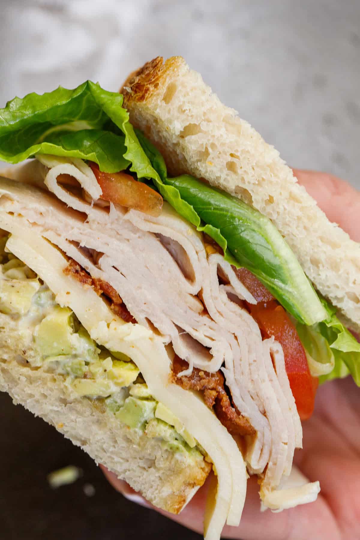 This turkey sandwich recipe is an easy sandwich to recreate, but makes for an incredible lunch. A sliced sandwich loaded with cheese, meat, and veggies.